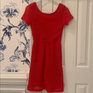 Red scoop back dress with lace overlay.